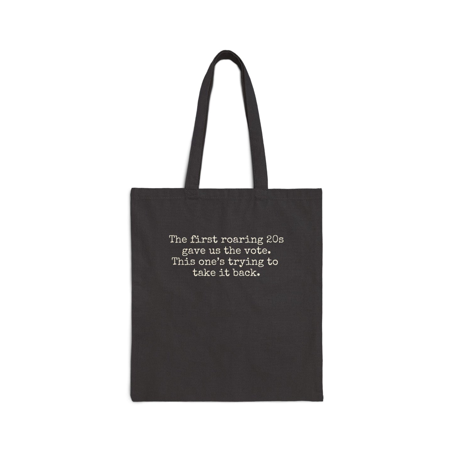 Black canvas tote bag with "the first roaring 20s gave us the vote. this one's trying to take it back" in cream text.