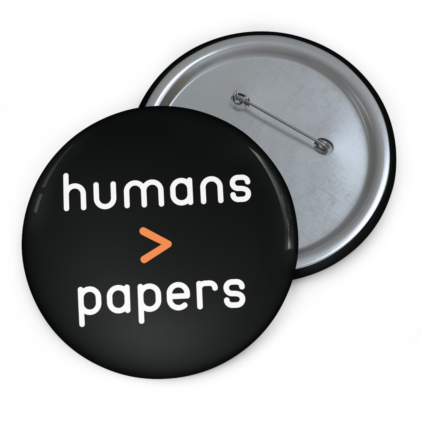 Black pin button with 'humans > papers' white text