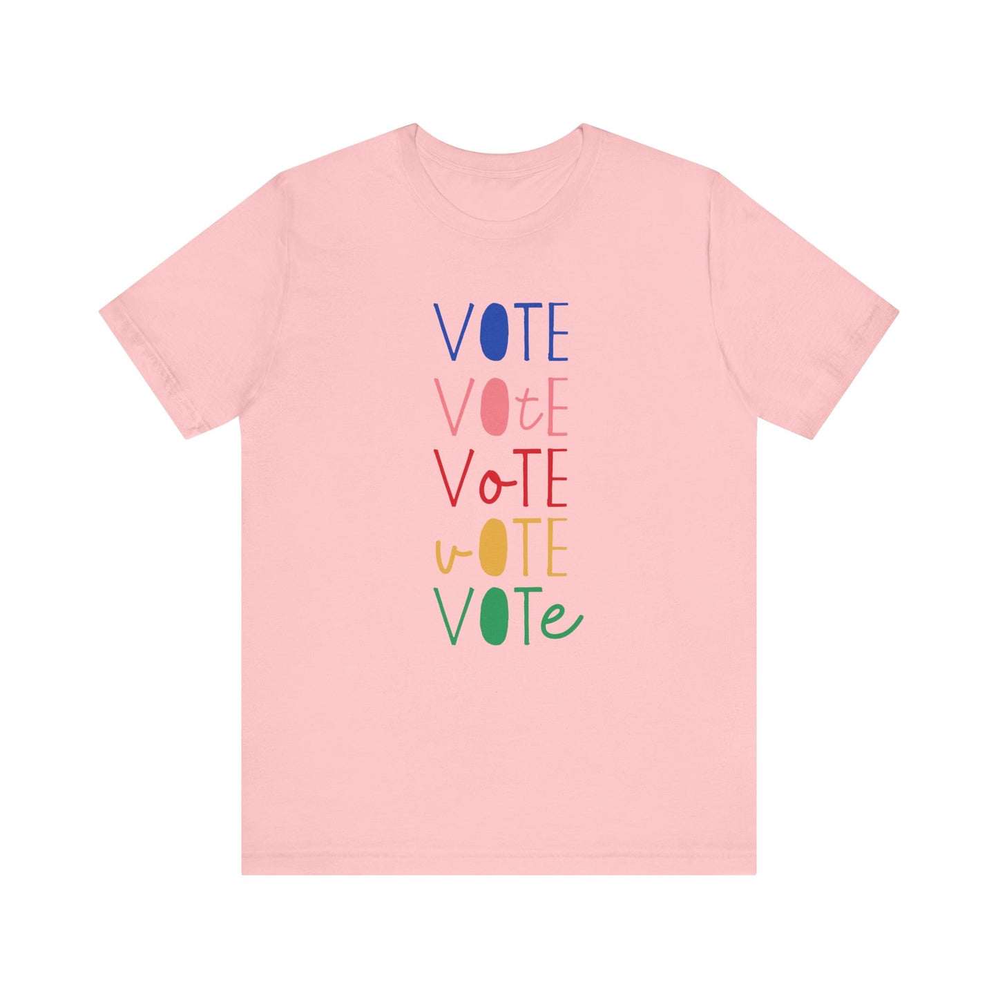 A light pink short-sleeve t-shirt with a vertical graphic on the chest spelling 'VOTE' in alternating bright colors (blue, pink, red, yellow, green) with oval letterforms, shown on a plain white background.