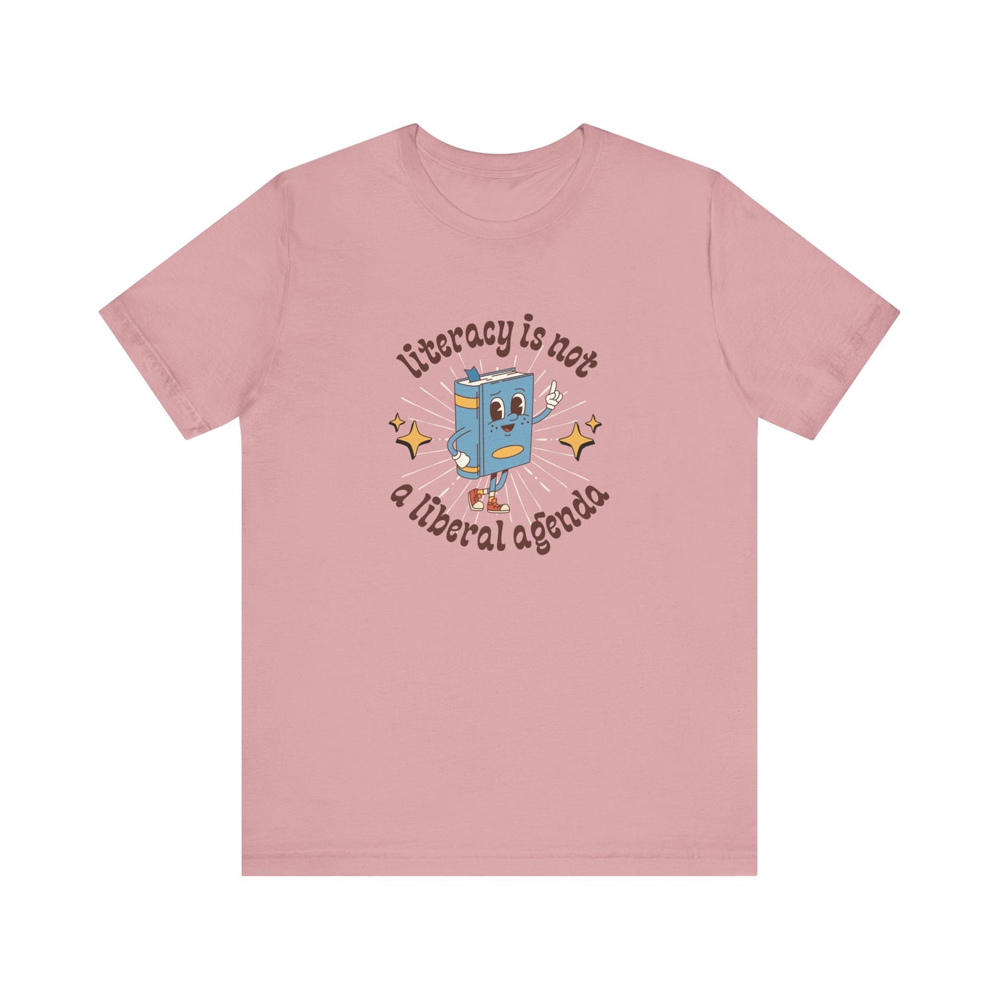 Pink t-shirt with a graphic of a retro book character and "literacy is not a liberal agenda" brown text
