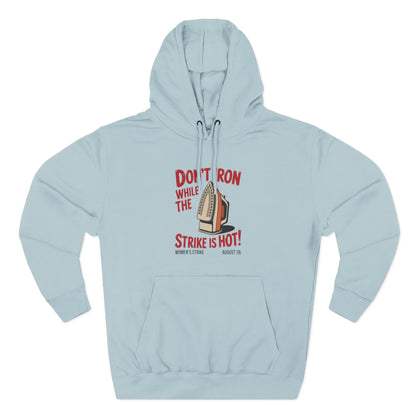 Light blue hoodie with a retro iron graphic and "don't iron while the strike is hot" red text