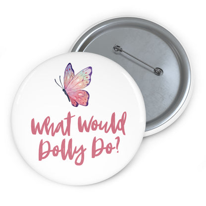 Two round pinback buttons shown on a white background, with the front button displaying a pink butterfly and the text 'What Would Dolly Do?' in pink script, and the back button showing the silver metal fastening.