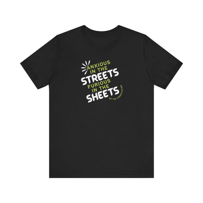 Black t-shirt with white and green text "anxious in the streets, furious in the sheets (of the constitution)"