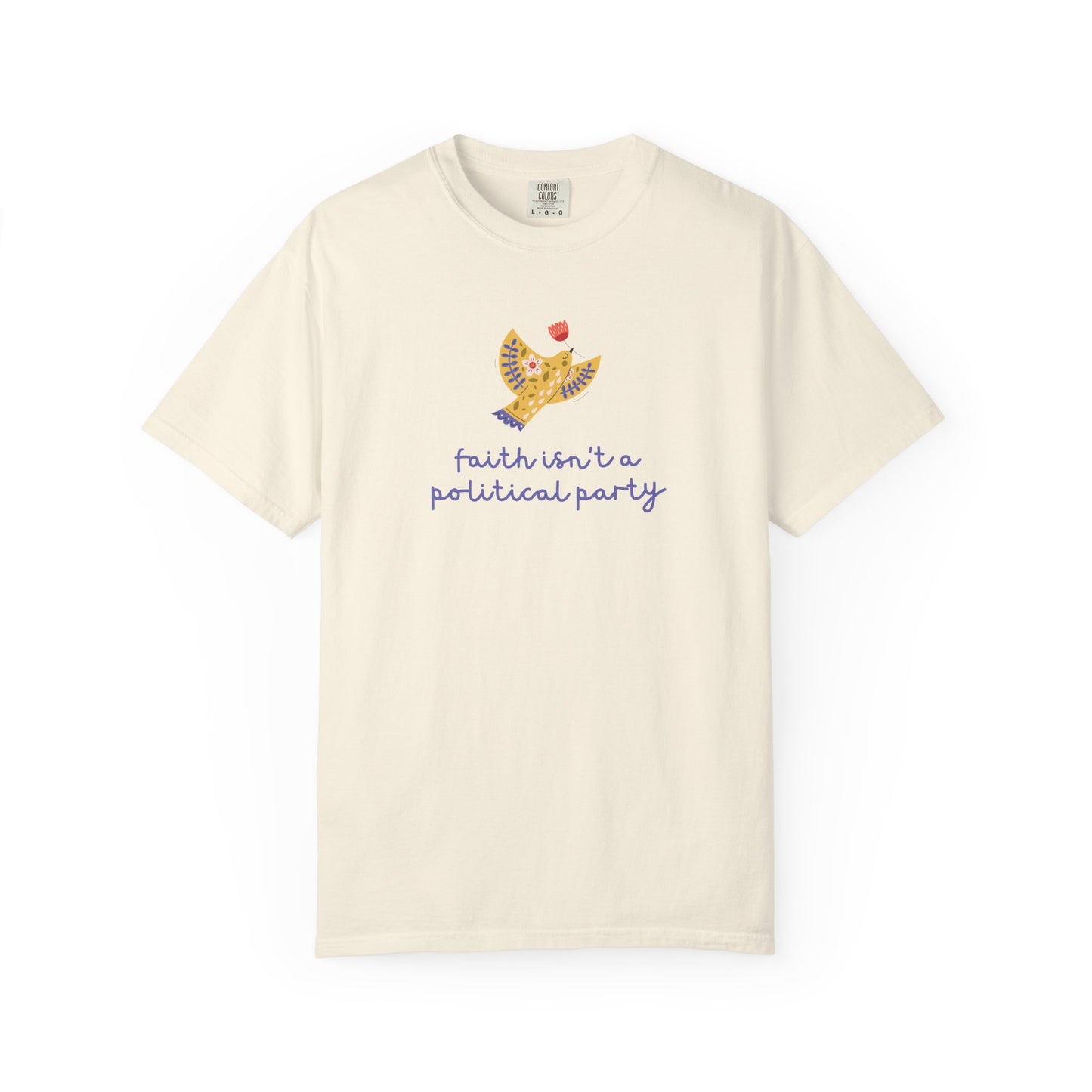 Beige t-shirt with a folk art dove graphic and purple text "faith isn't a political party"