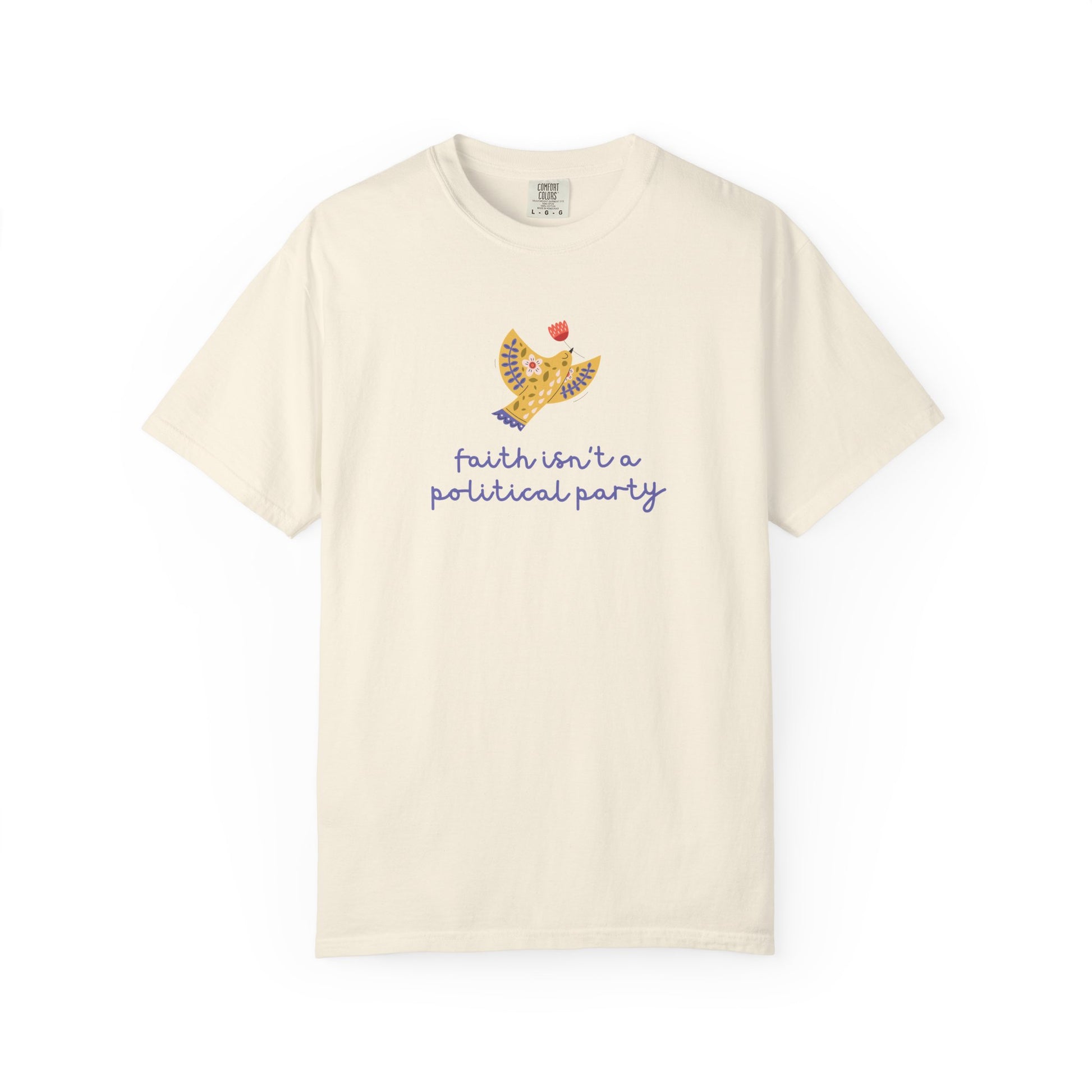 Beige t-shirt with a folk art dove graphic and purple text "faith isn't a political party"