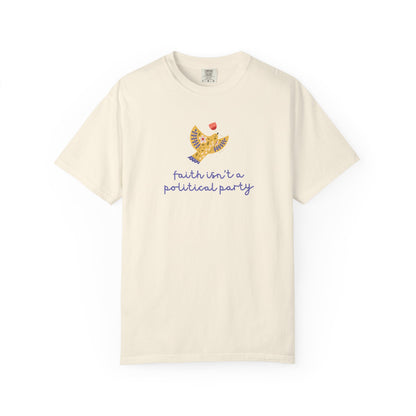 Beige t-shirt with a folk art dove graphic and purple text "faith isn't a political party"