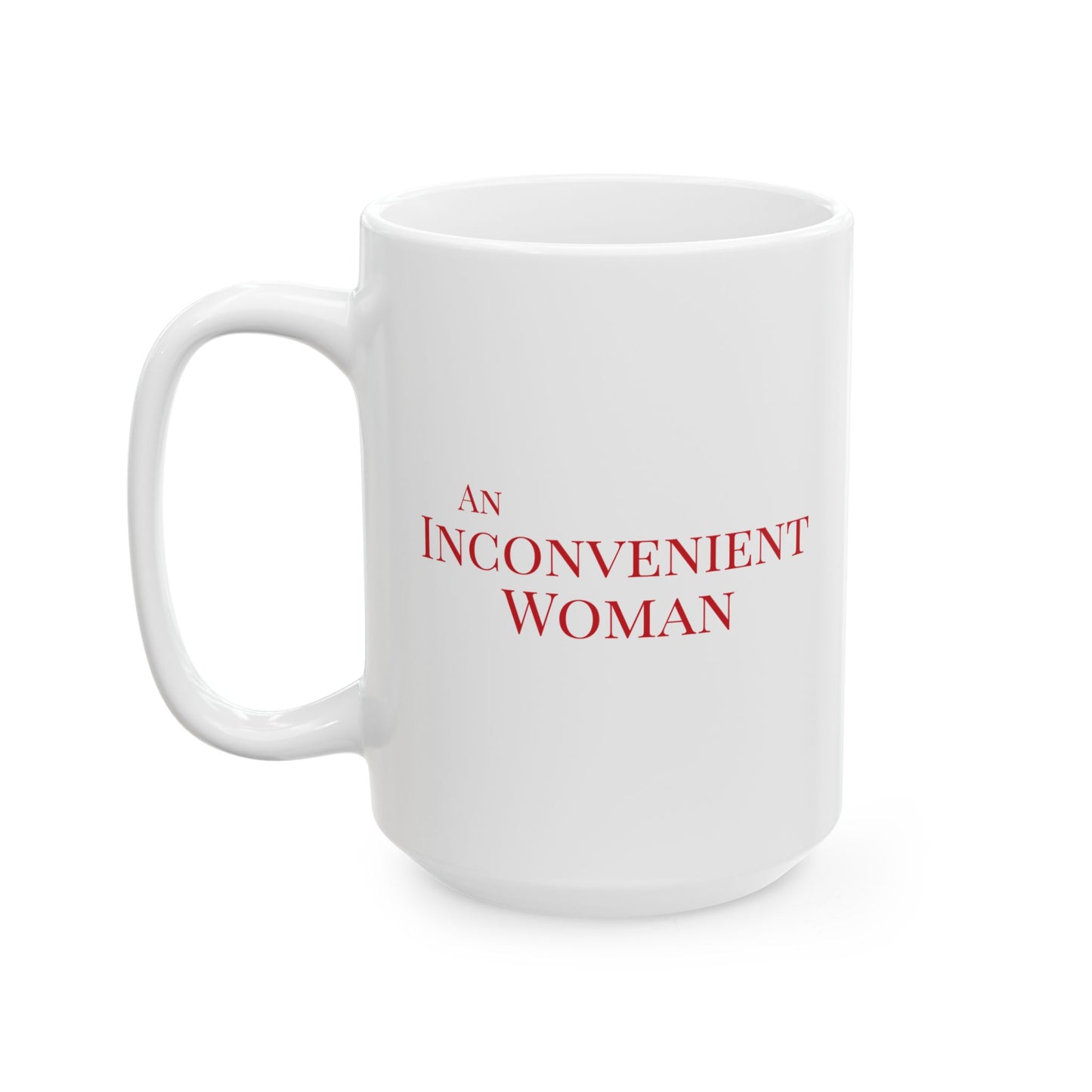 White 15 oz mug with red text 'AN INCONVENIENT WOMAN' 