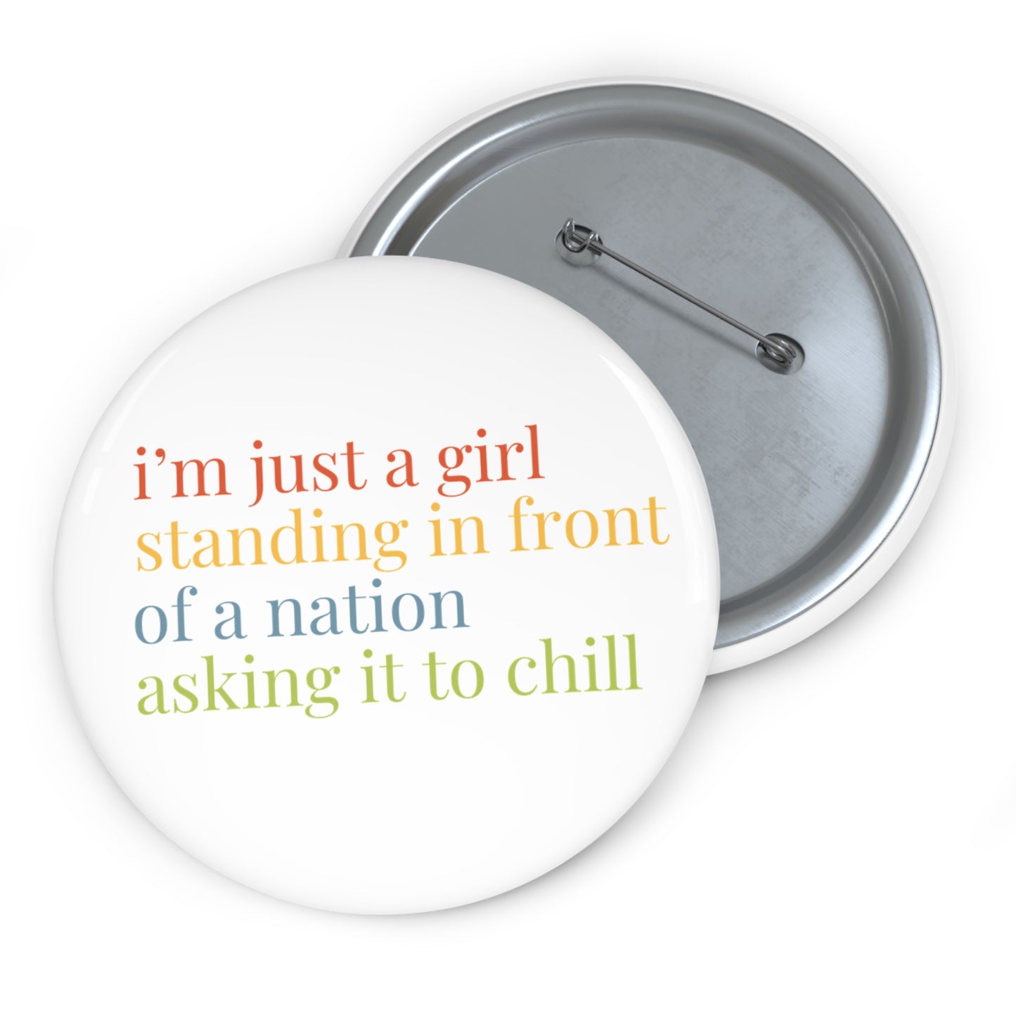 Button badge with colorful text 'i'm just a girl standing in front of a nation asking it to chill' on a white 