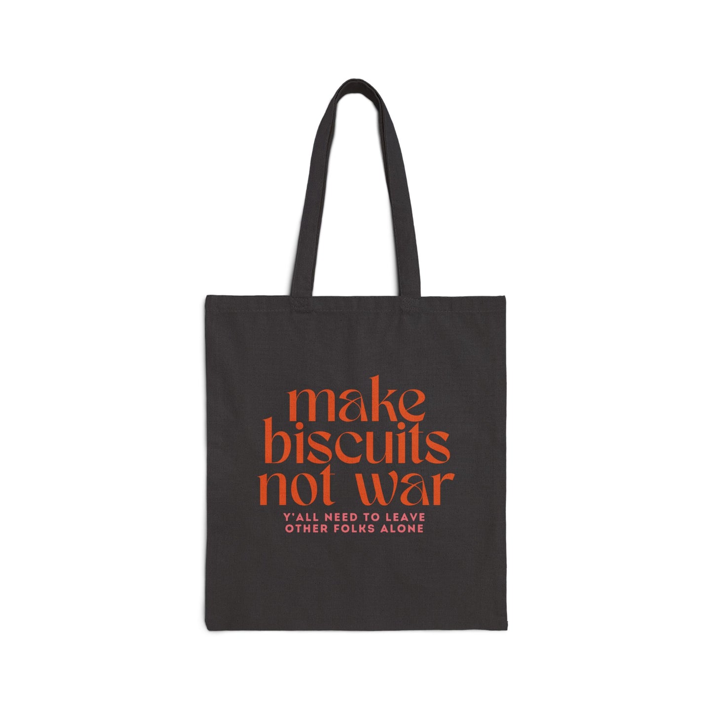 Black canvas tote bag with orange text 'make biscuits not war' and smaller pink text 'y'all need to leave other folks alone' 