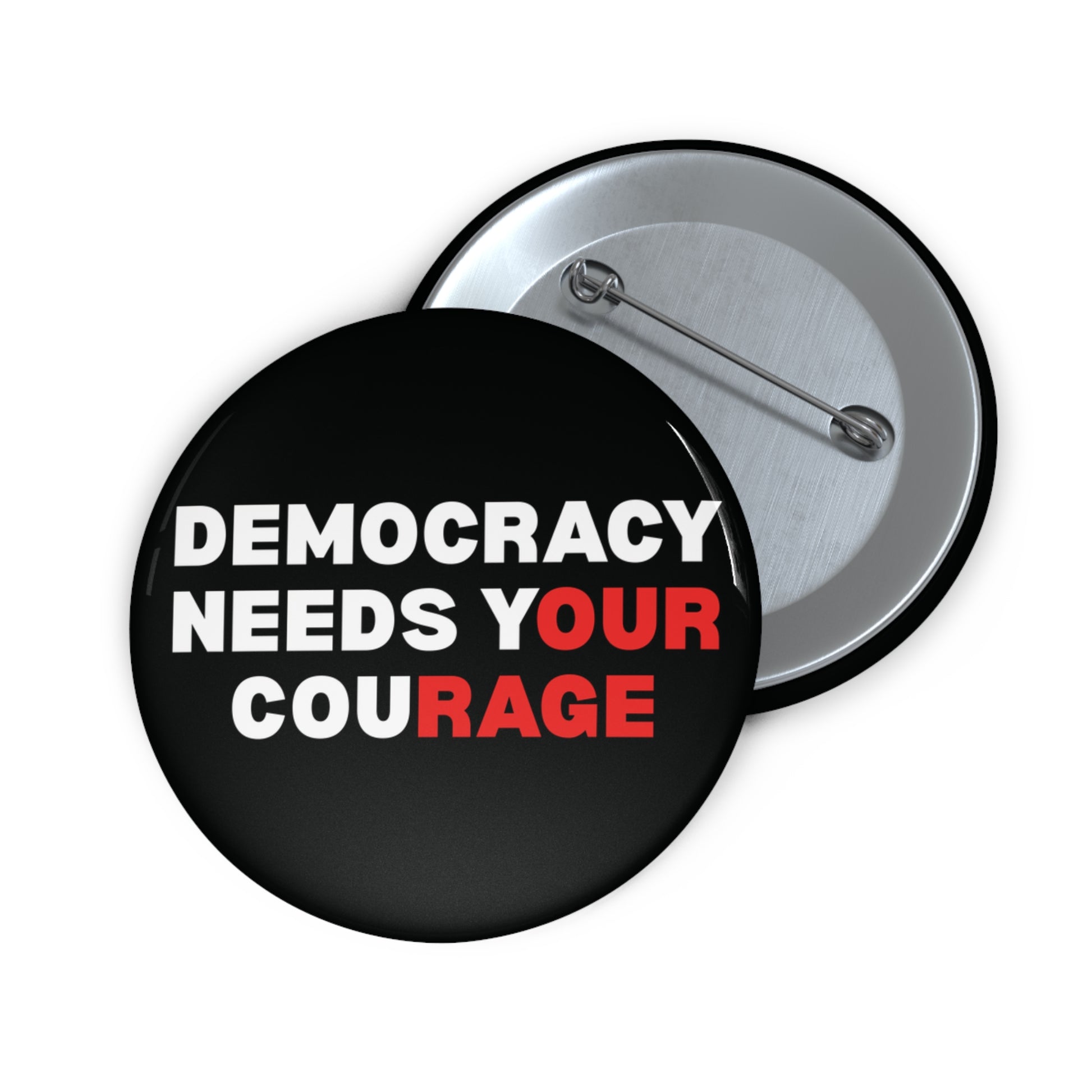 Black pin button with 'DEMOCRACY NEEDS YOUR COURAGE' white and red text
