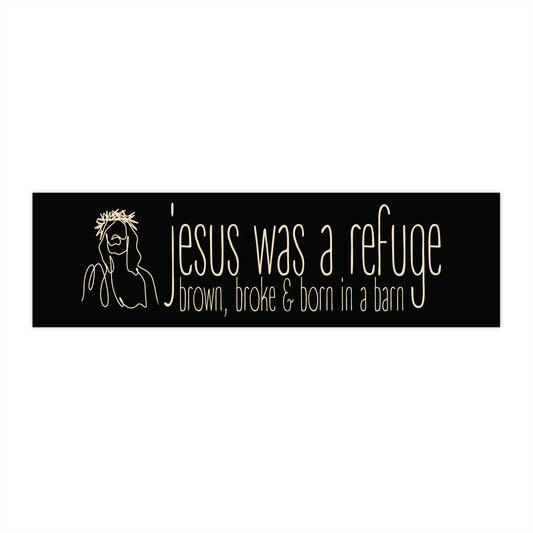Bumper sticker with text 'Jesus was a refuge; brown, broke & born in a barn' on a black background