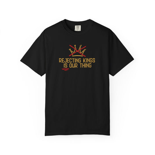 Black t-shirt with a gold sketch graphic of a crown with a red X over it and gold text "REJECTING KINGS IS OUR THING"