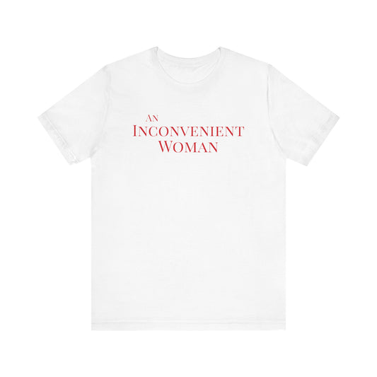 White t-shirt with red text "An Inconvenient Woman"