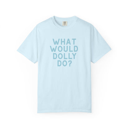 A light blue short-sleeve crewneck t-shirt with the text 'WHAT WOULD DOLLY DO?' printed in a matching light blue font on the front, displayed against a clean white background.