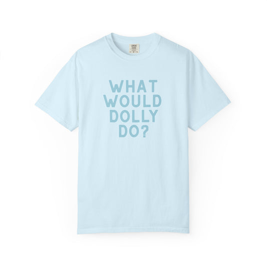 A light blue short-sleeve crewneck t-shirt with the text 'WHAT WOULD DOLLY DO?' printed in a matching light blue font on the front, displayed against a clean white background.