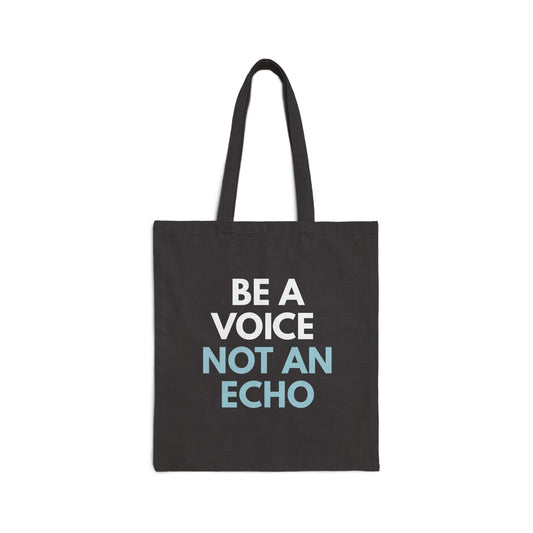 Black canvas tote bag with 'Be a Voice Not an Echo' blue and white text