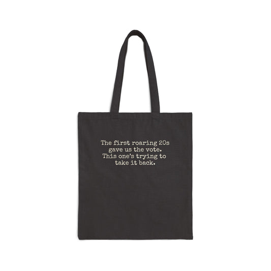 Black canvas tote bag with "the first roaring 20s gave us the vote. this one's trying to take it back" in cream text.