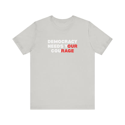 Gray t-shirt with text 'Democracy Needs Your Courage' in white and red