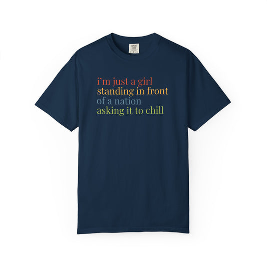 Navy blue t-shirt with colorful text "i'm just a girl, standing in front of a nation, asking it to chill"