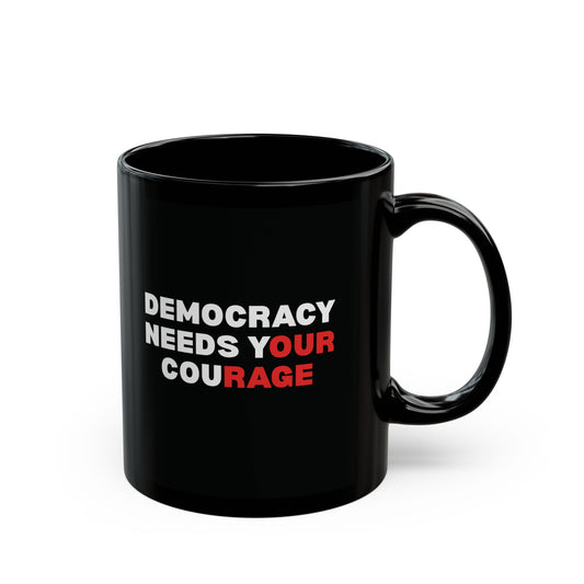 Black ceramic 11 oz coffee or tea mug with 'DEMOCRACY NEEDS YOUR COURAGE' white and red text
