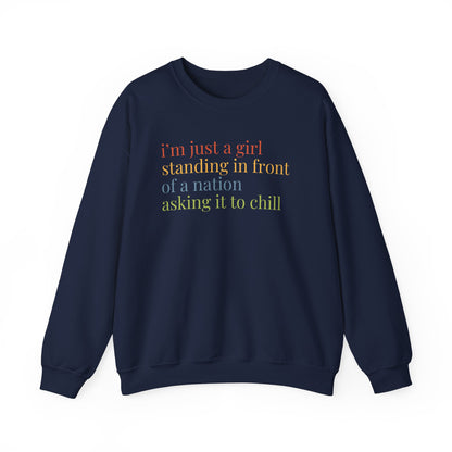Navy blue Unisex crewneck sweatshirt with colorful “I'm just a girl, standing in front of a nation, asking it to chill” text
