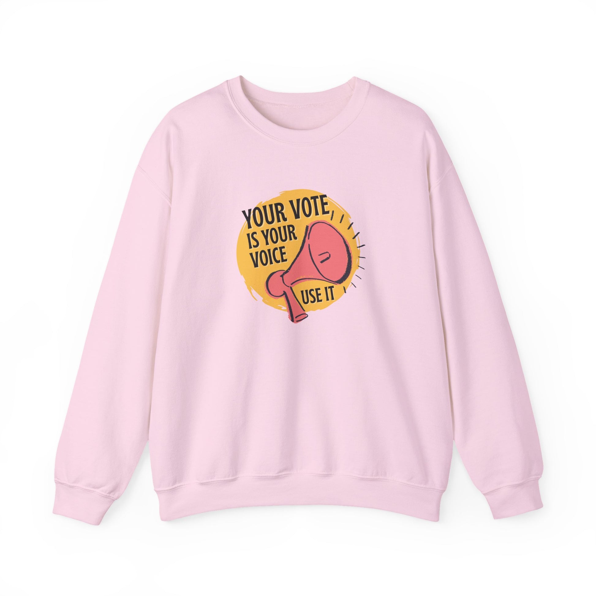 Light pink sweatshirt with a coral megaphone graphic against a bright yellow circle and black text "your vote is your voice, use it"