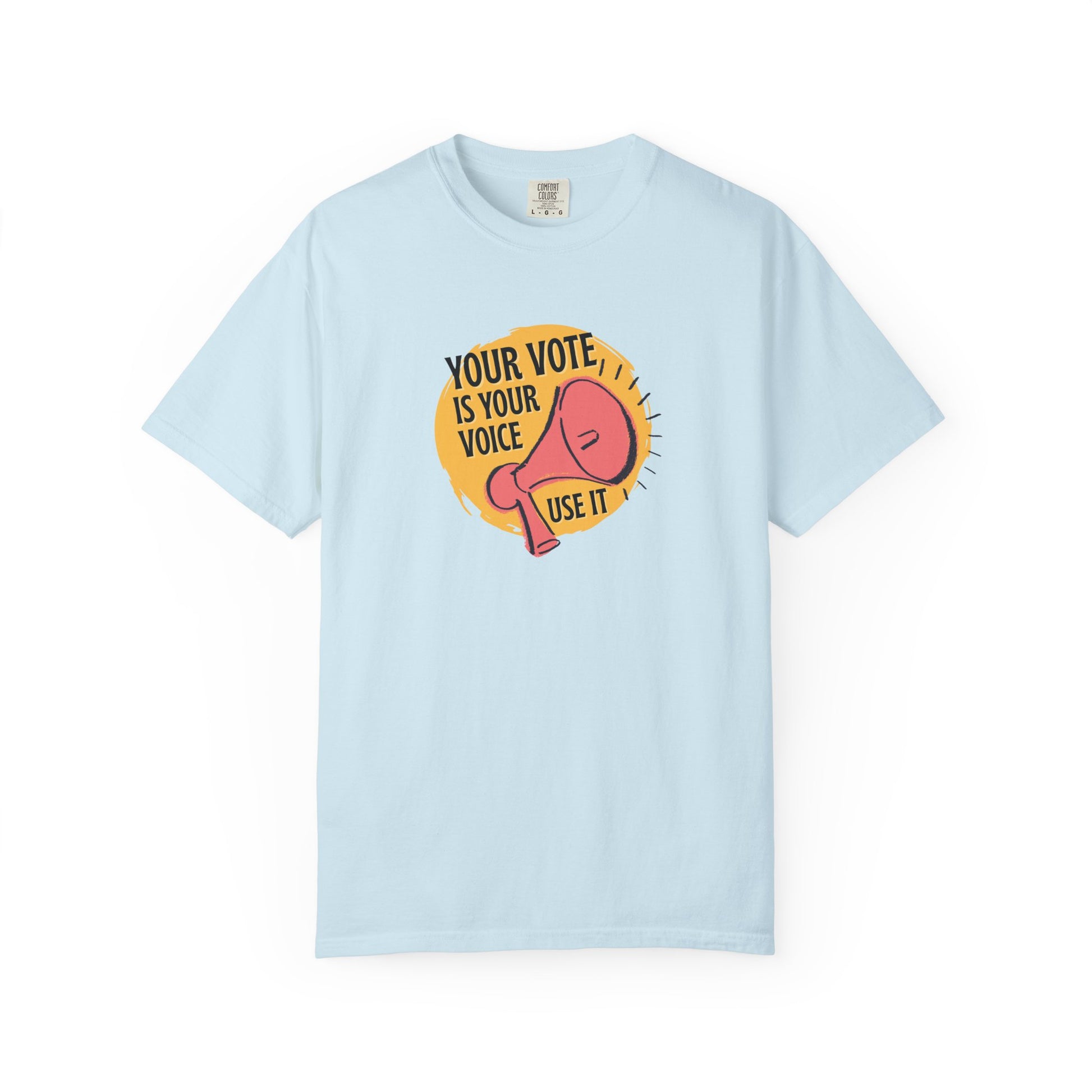 Light blue t-shirt with a coral megaphone graphic against a bright yellow circle and black text 'Your vote is your voice, use it' 