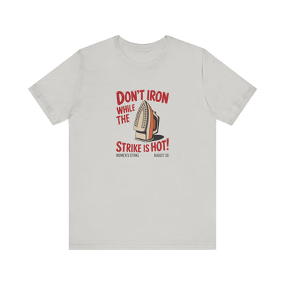 Light gray t-shirt with a vintage iron graphic and red text "don't iron while the strike is hot" 