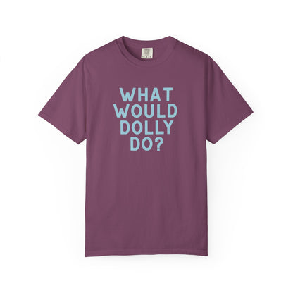 An eggplant purple short-sleeve crewneck t-shirt with the text 'WHAT WOULD DOLLY DO?' printed in a matching light blue font on the front, displayed against a clean white background.