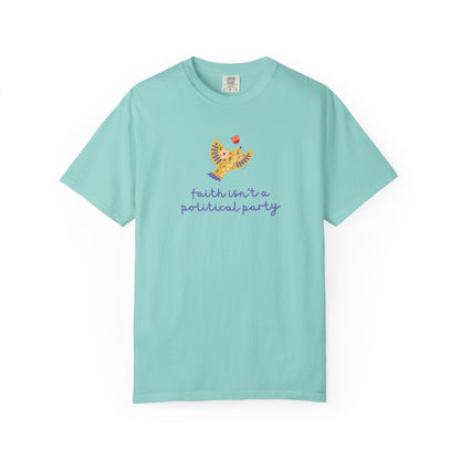 Mint green t-shirt with a folk art dove graphic and purple text "faith isn't a political party"