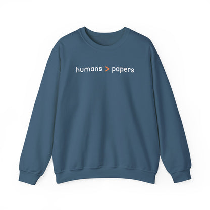 Indigo blue unisex crewneck sweatshirt with 'humans > papers' white text
