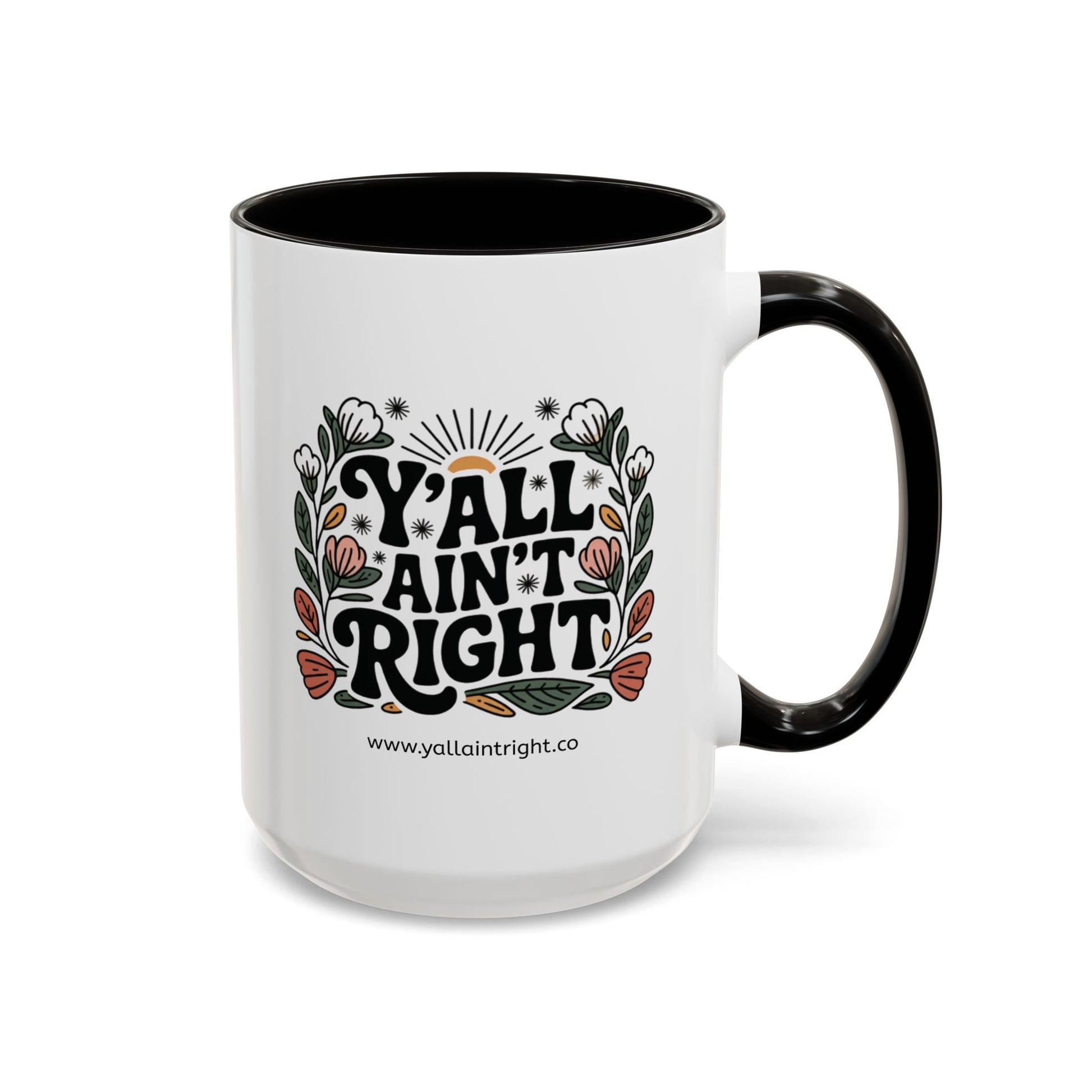 White ceramic coffee or tea mug with black interior and handle, featuring "Y'all Ain't Right" decorative text and floral elements