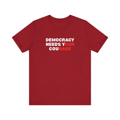 Red t-shirt with text 'Democracy Needs Your Courage' in white and red