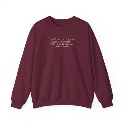 Maroon unisex crewneck sweatshirt with "the first roaring 20s gave us the vote. This one's trying to take it back" cream text
