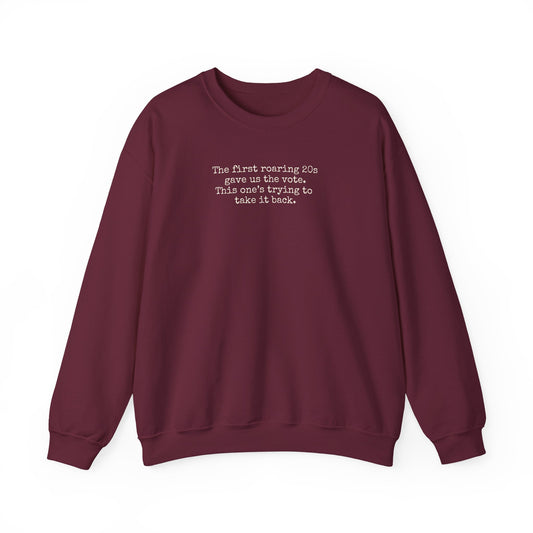 Maroon unisex crewneck sweatshirt with "the first roaring 20s gave us the vote. This one's trying to take it back" cream text
