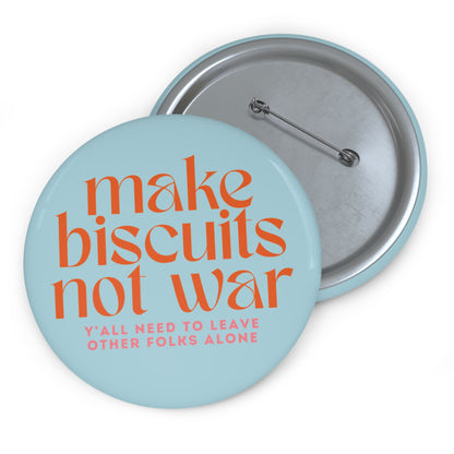 Light blue button with 'make biscuits not war' orange text and smaller pink text "y'all need to leave other folks alone"
