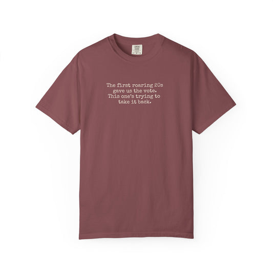 Light maroon unisex Comfort Colors t-shirt  with "the first roaring 20s gave us the vote. this one's trying to take it back" cream text.