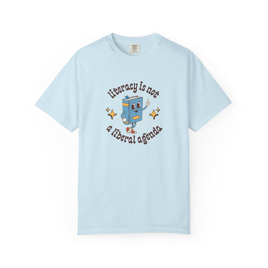 Light blue t-shirt with a cartoon book character and "literacy is not a liberal agenda" brown text