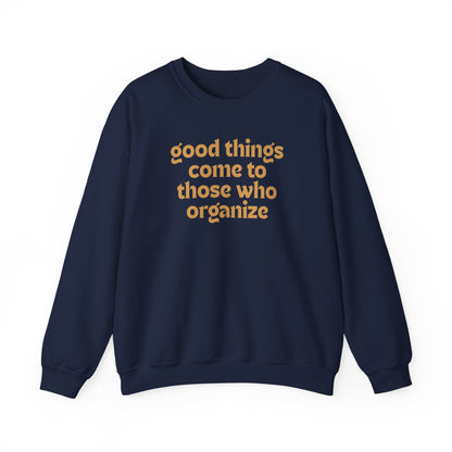 Navy blue unisex crewneck sweatshirt with 'good things come to those who organize' gold text