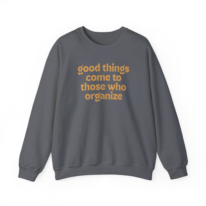 Gray unisex crewneck sweatshirt with 'good things come to those who organize' gold text