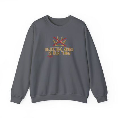 Gray sweatshirt with gold sketch graphic of a crown with a red X over it and gold text "REJECTING KINGS IS OUR THING"