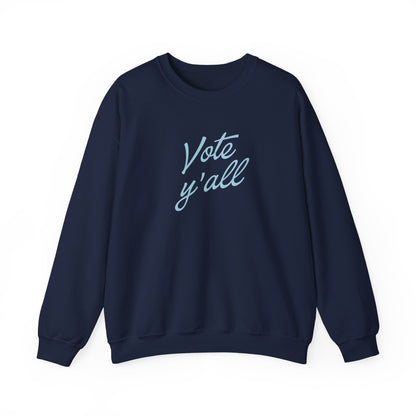 A navy blue crewneck sweatshirt with the words 'Vote y'all' printed in a light blue cursive font on the chest