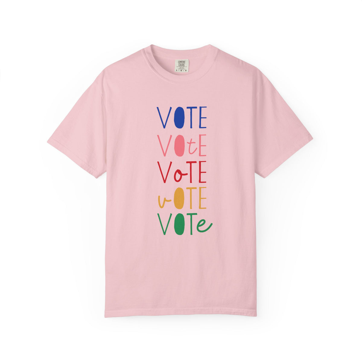 A light pink short-sleeve t-shirt with a vertical graphic spelling 'VOTE' in alternating blue, pink, red, yellow, and green colors, displayed on a clean white background.