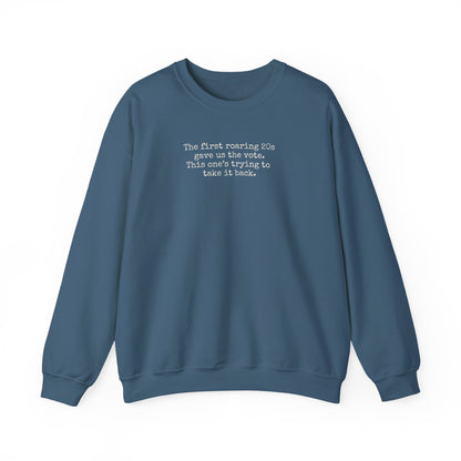 Indigo blue unisex crewneck sweatshirt with "the first roaring 20s gave us the vote. This one's trying to take it back" cream text