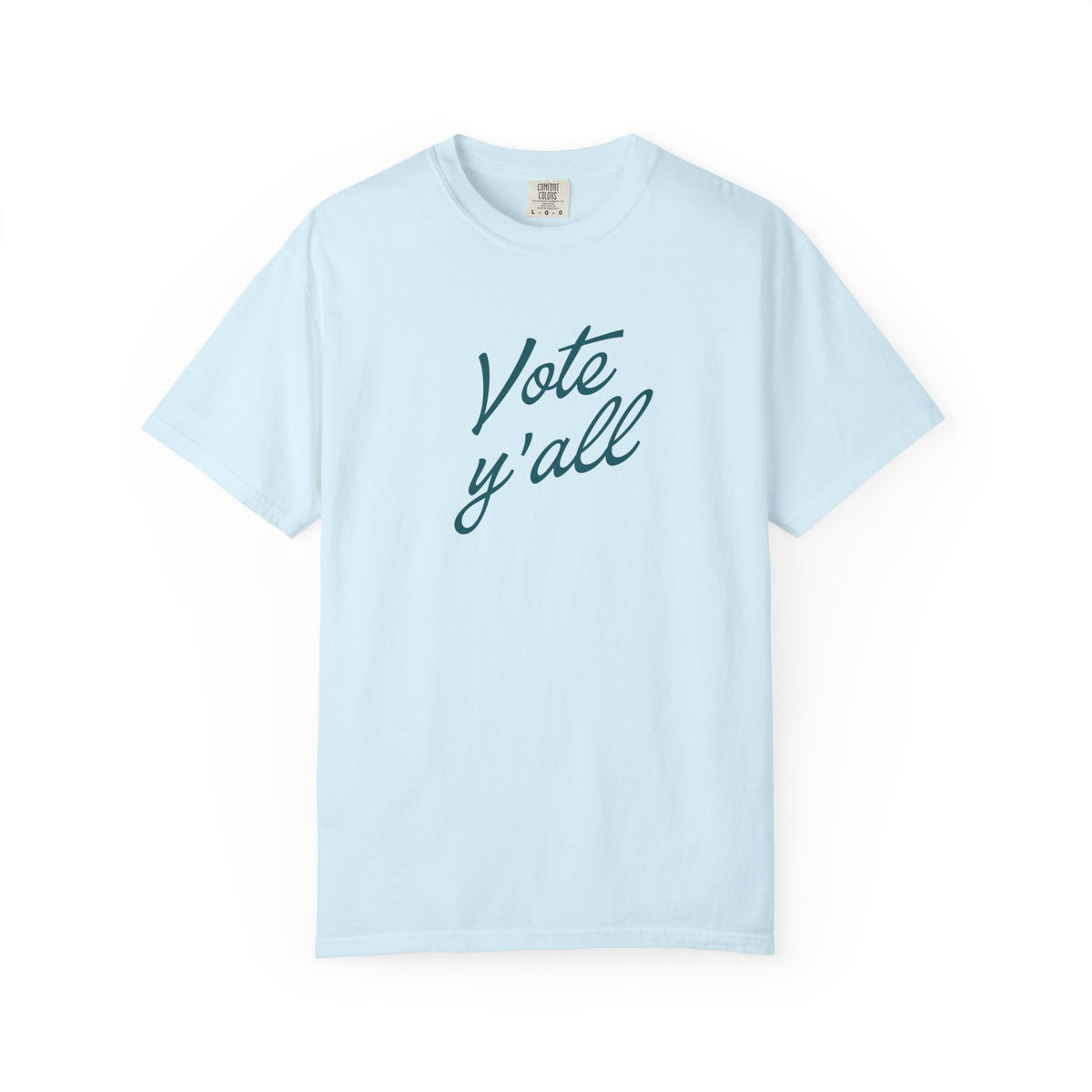 A light blue short-sleeve crewneck t-shirt with the words 'Vote y'all' printed in a dark teal cursive font across the chest, displayed on a clean white background.