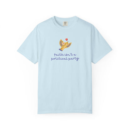 Light blue t-shirt with a folk art dove graphic and purple text "faith isn't a political party"