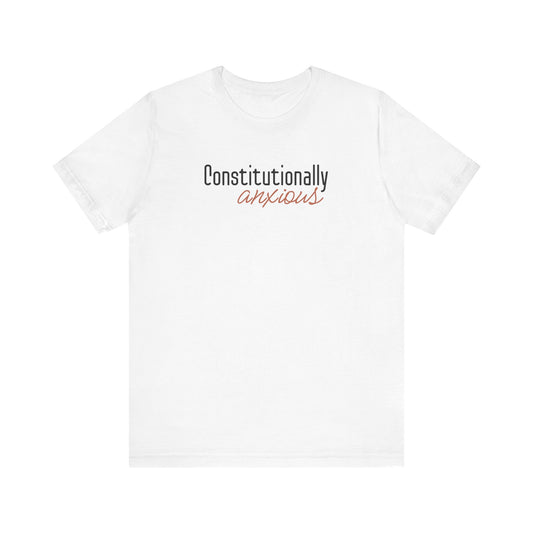 White t-shirt with 'Constitutionally anxious' text in black and orange
