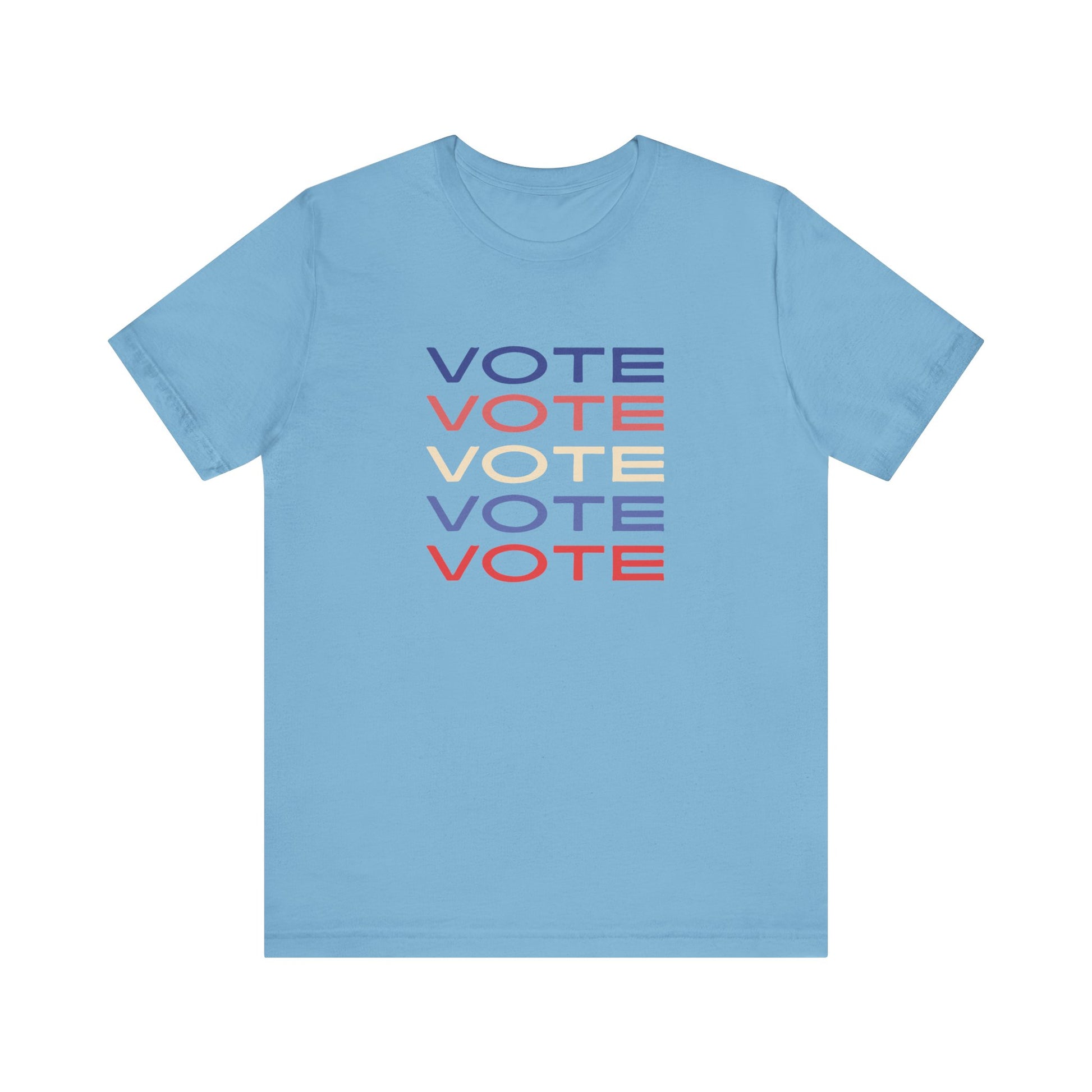 A blue short-sleeve crewneck t-shirt featuring a stacked graphic print of the word 'VOTE' in blue, red, and cream on the chest.