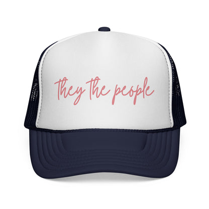 Navy blue and white mesh trucker hat with 'They the people' text in pink 