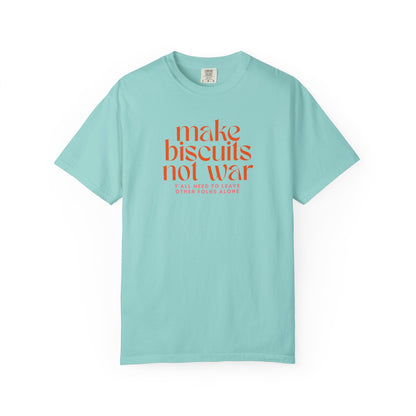 Light teal t-shirt with orange text 'make biscuits not war' with smaller pink text "y'all need to leave other folks alone" 
